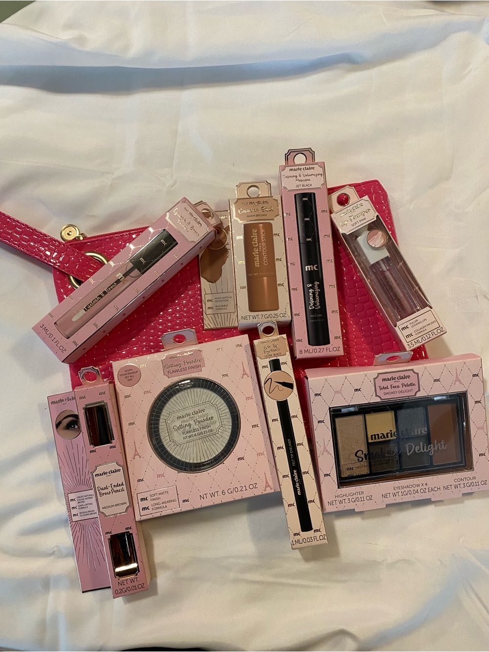 Marie Claire makeup collection with with pink crocodile textured cosmetic bag